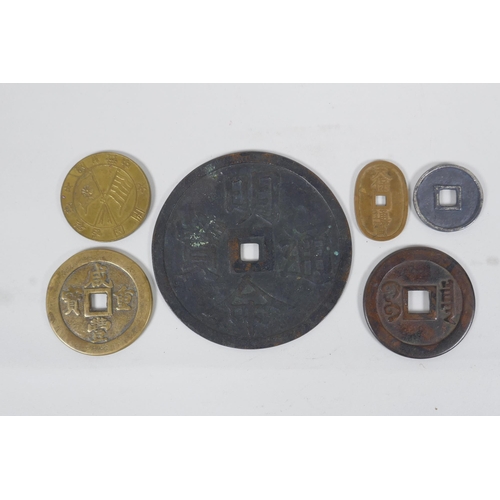 194 - A large Chinese bronze pi-disc, and other smaller bronze pi-discs and tokens, largest 12cm diameter