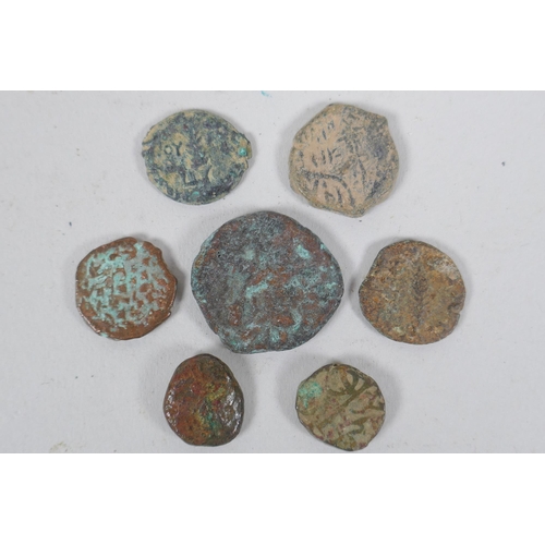 196 - Seven archaic eastern metal coins, largest 2cm