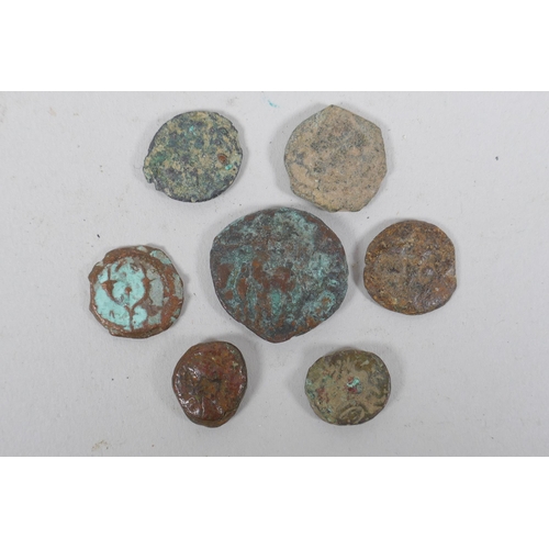 196 - Seven archaic eastern metal coins, largest 2cm