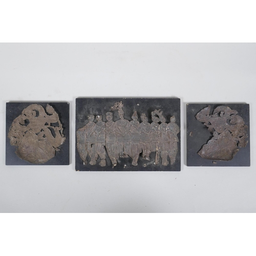 201 - Three Mongolian white metal foil raised figural plaques, on ebonised wood panels, largest 20 x 14cm