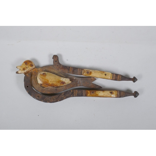 204 - An antique Indian Betel nut cutter in the form of a bird, with bone mounts, 24cm long