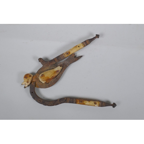 204 - An antique Indian Betel nut cutter in the form of a bird, with bone mounts, 24cm long