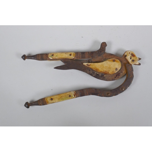 204 - An antique Indian Betel nut cutter in the form of a bird, with bone mounts, 24cm long