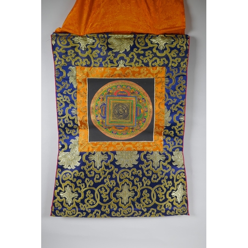 207 - A hand painted Tibetan Mandala, in hanging silk mount, 48 x 58cm