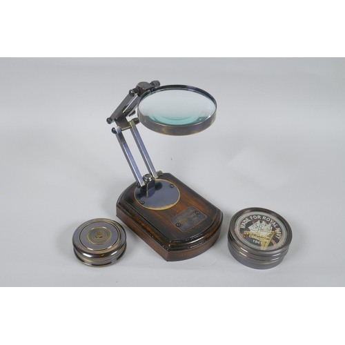 215 - A brass desk top magnifying glass and two reproduction brass compasses, lens 8cm diameter, 1AF