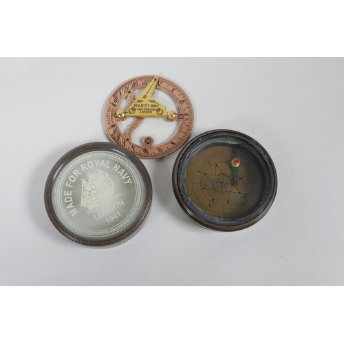 215 - A brass desk top magnifying glass and two reproduction brass compasses, lens 8cm diameter, 1AF