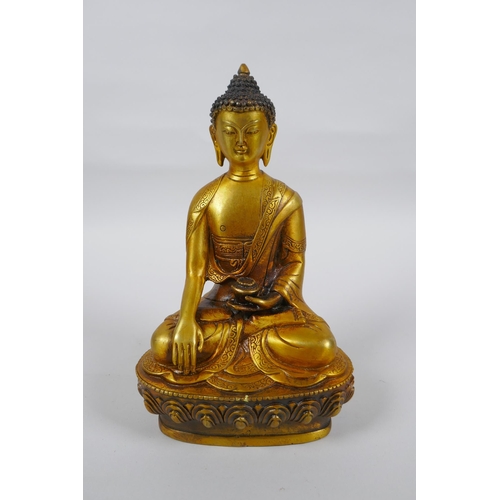 217 - A Tibetan gilt metal Buddha seated in meditation, double vajra mark to base, 20cm high