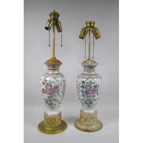 22 - A pair of famille rose porcelain vases converted to lamps, with matching painted bases, 67cm highest