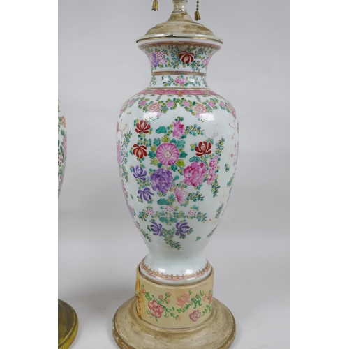 22 - A pair of famille rose porcelain vases converted to lamps, with matching painted bases, 67cm highest