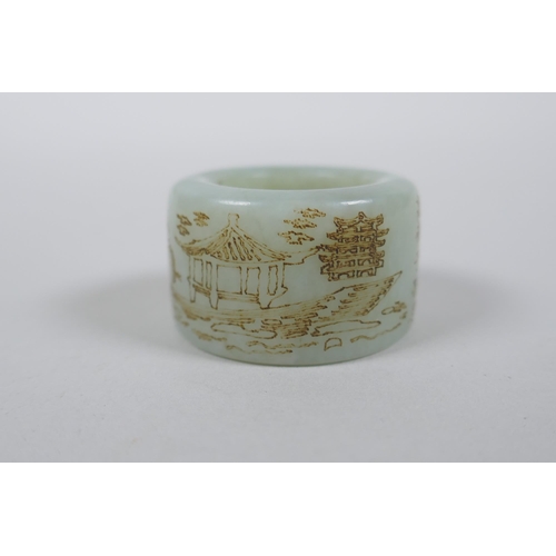 225 - A Chinese celadon jade archer's thumb ring with engraved character inscription decoration, 3cm diame... 