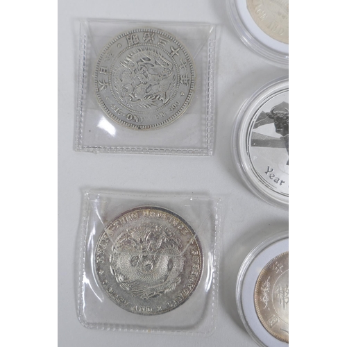 229 - A quantity of Chinese facsimile (replica) white metal coinage, many coins in collector's cases