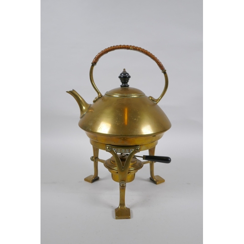 23 - An Arts and Crafts brass spirit kettle, 29cm high