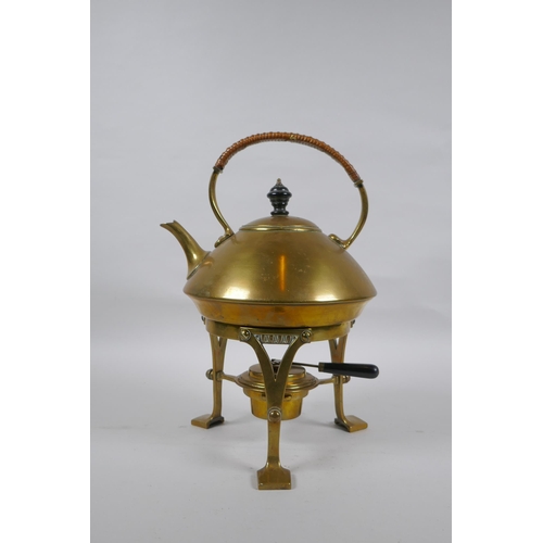 23 - An Arts and Crafts brass spirit kettle, 29cm high