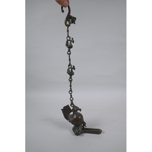 241 - An antique Murghal bronze hanging oil lamp in the form of a bird, 44cm drop