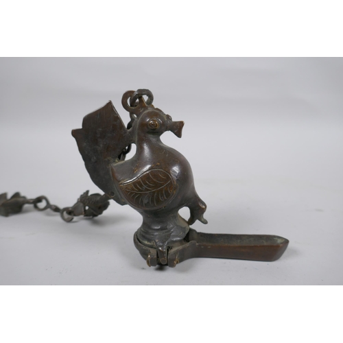 241 - An antique Murghal bronze hanging oil lamp in the form of a bird, 44cm drop