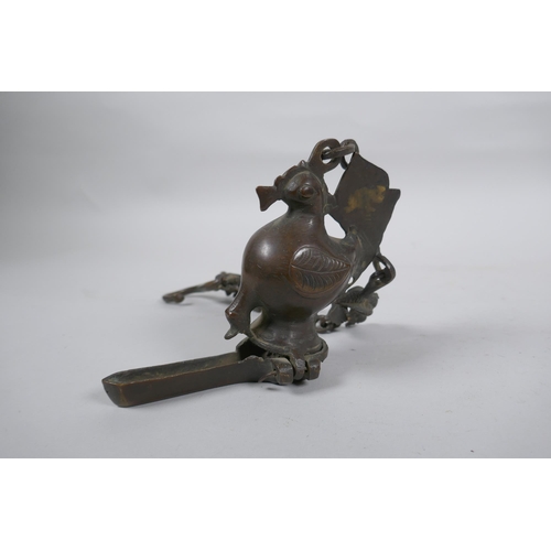 241 - An antique Murghal bronze hanging oil lamp in the form of a bird, 44cm drop