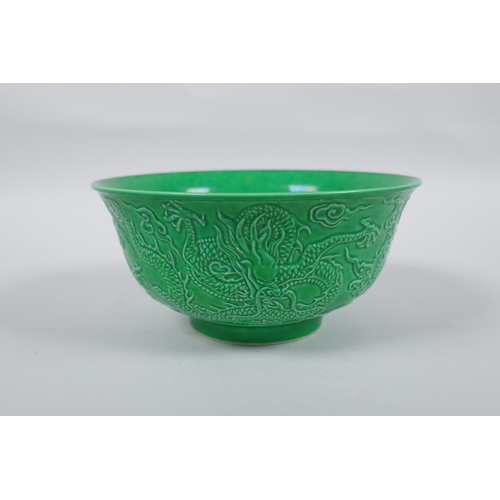 243 - A Chinese apple green glazed porcelain rice bowl with raised dragon decoration, Zengde 6 character m... 