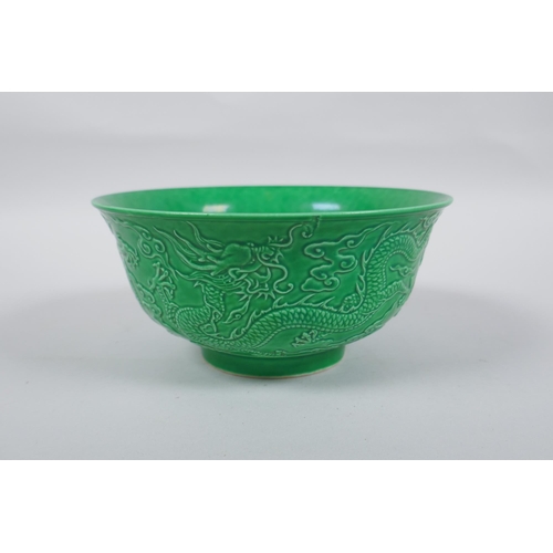 243 - A Chinese apple green glazed porcelain rice bowl with raised dragon decoration, Zengde 6 character m... 