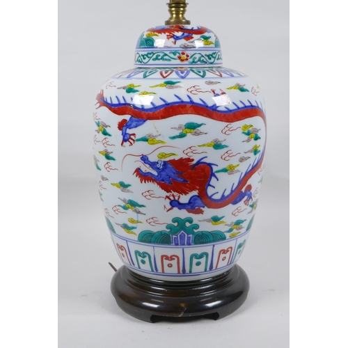 250 - A Chinese Wucai porcelain jar and cover with dragon decoration, converted to a lamp, 41cm high