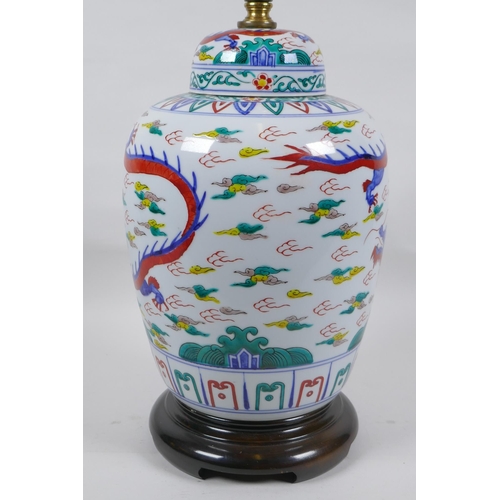 250 - A Chinese Wucai porcelain jar and cover with dragon decoration, converted to a lamp, 41cm high