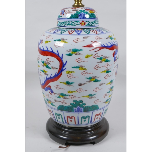 250 - A Chinese Wucai porcelain jar and cover with dragon decoration, converted to a lamp, 41cm high