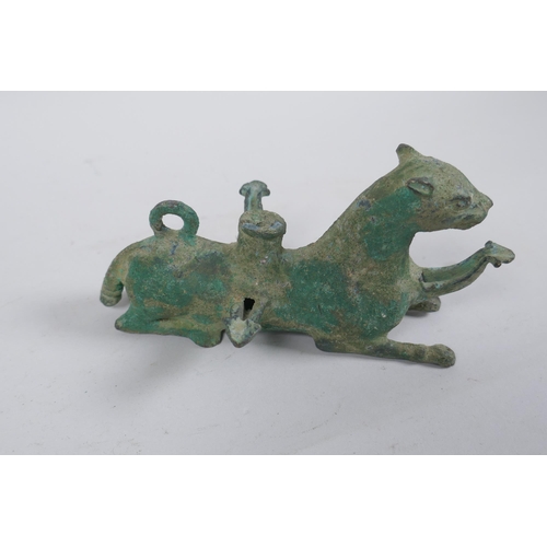 255 - A Persian cast metal oil lamp in the form of a lion, 15cm long