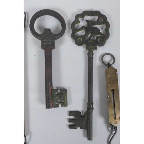 259 - Two antique Salter brass spring balance scales, and two cast iron oversized keys, largest 35cm