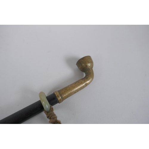 262 - A Chinese tobacco pipe and pouch, the hardwood pipe with jade and metal mounts, 39cm long