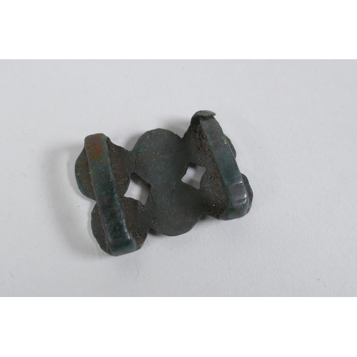 266 - A quantity of bronze belt buckles with a green patina and spiral decoration, 4 x 3cm