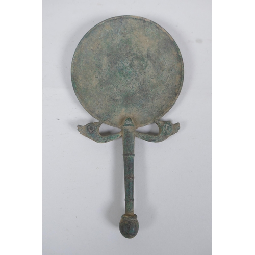 267 - An antique bronze hand mirror with bird head decoration, possibly Etruscan, 23cm long