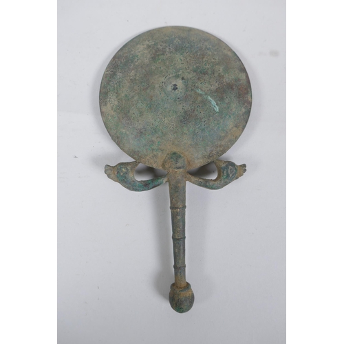 267 - An antique bronze hand mirror with bird head decoration, possibly Etruscan, 23cm long