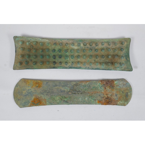 269 - Two early bronze armour mounts, longest 25 x 7cm