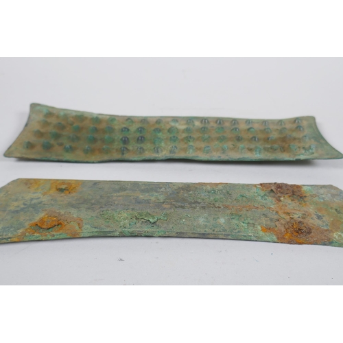 269 - Two early bronze armour mounts, longest 25 x 7cm