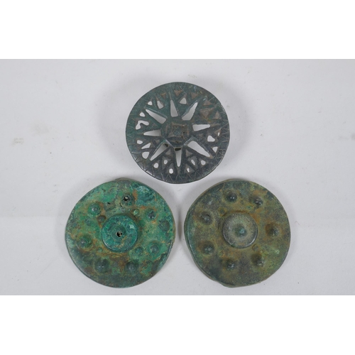 270 - Three early bronze armour mounts, 7cm diameter