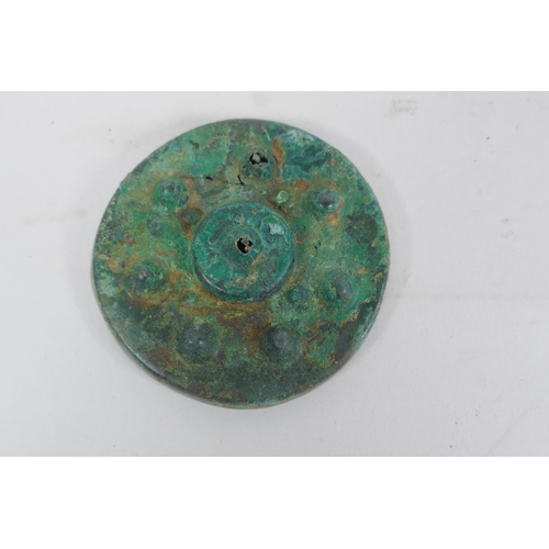 270 - Three early bronze armour mounts, 7cm diameter