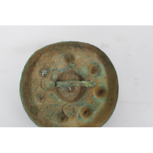 270 - Three early bronze armour mounts, 7cm diameter