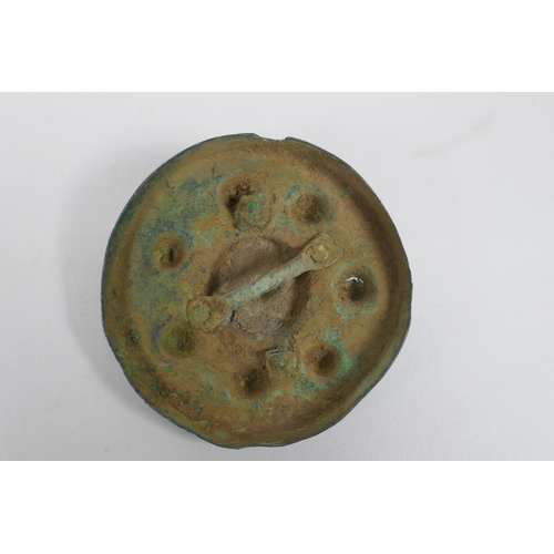 270 - Three early bronze armour mounts, 7cm diameter