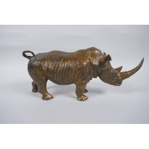 271 - A gilt bronzed metal rhinoceros, 24cm long