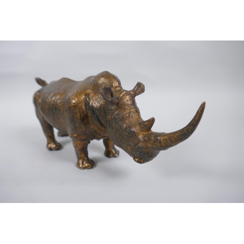 271 - A gilt bronzed metal rhinoceros, 24cm long