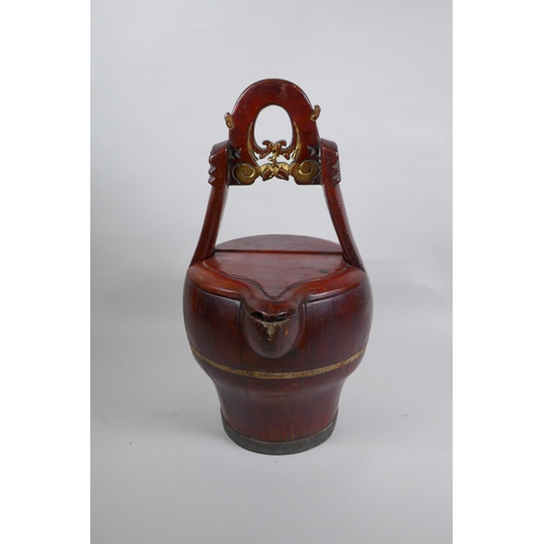 273 - An antique Chinese red lacquered wood basket with spout and carved handle, 40cm high