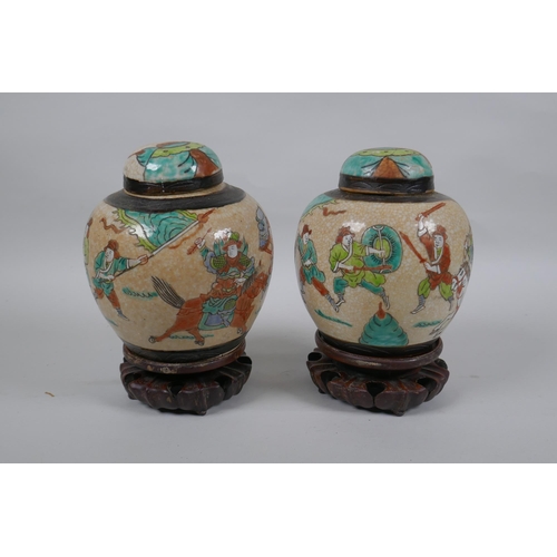 276 - A pair of antique Chinese crackleware ginger jars and covers with polychrome enamel decoration of wa... 