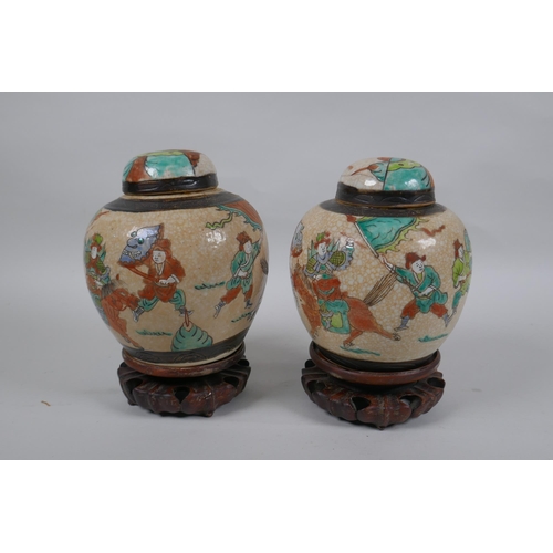 276 - A pair of antique Chinese crackleware ginger jars and covers with polychrome enamel decoration of wa... 