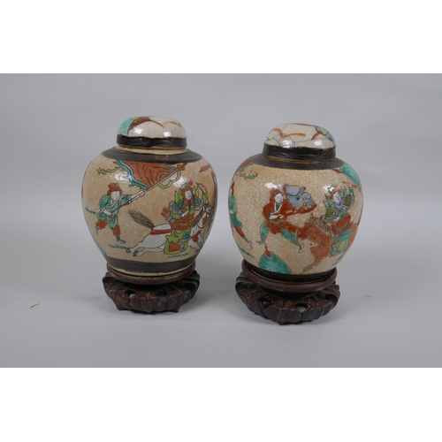 276 - A pair of antique Chinese crackleware ginger jars and covers with polychrome enamel decoration of wa... 