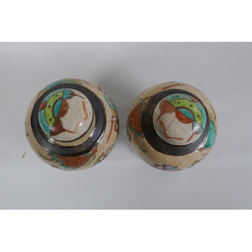 276 - A pair of antique Chinese crackleware ginger jars and covers with polychrome enamel decoration of wa... 