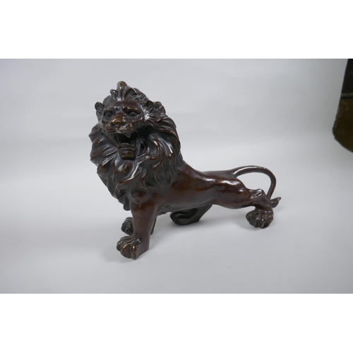 284 - A filled bronze figure of a lion, 26cm long