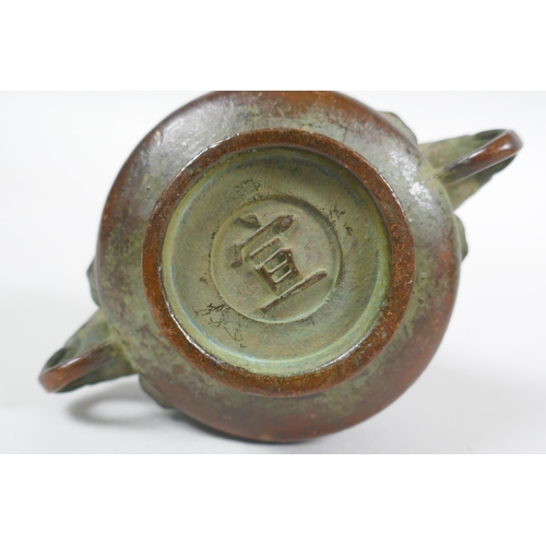 293 - A miniature Chinese bronze censer with two elephant mask handles, and another with lion mask handles... 