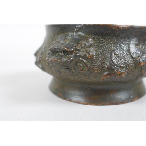 293 - A miniature Chinese bronze censer with two elephant mask handles, and another with lion mask handles... 