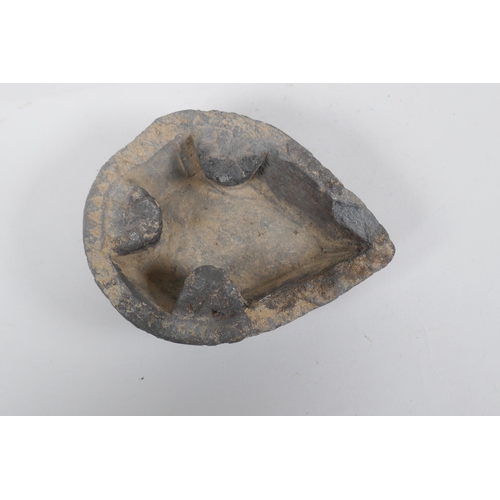 309 - An antique carved stone oil lamp, 13 x 10cm