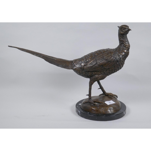 31 - A bronze figure of a pheasant, mounted on a marble base, unsigned, 33cm high