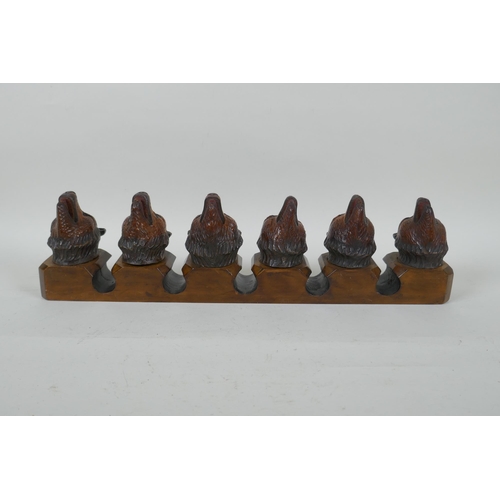 315 - An antique Black Forest carved wood pipe rack with bear's head decoration, a pair of turned wood tob... 